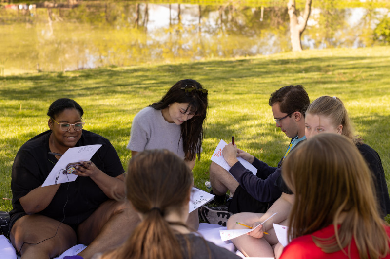 Students working in a circle outside